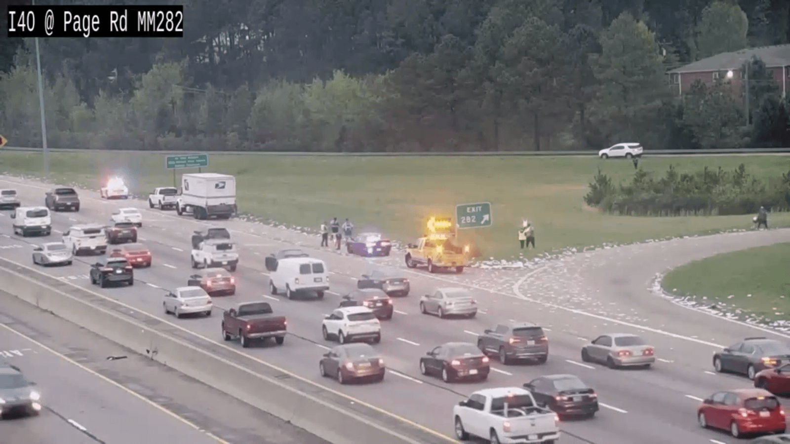 Spilled mail on side of I-40 slows traffic near Page Road in Durham